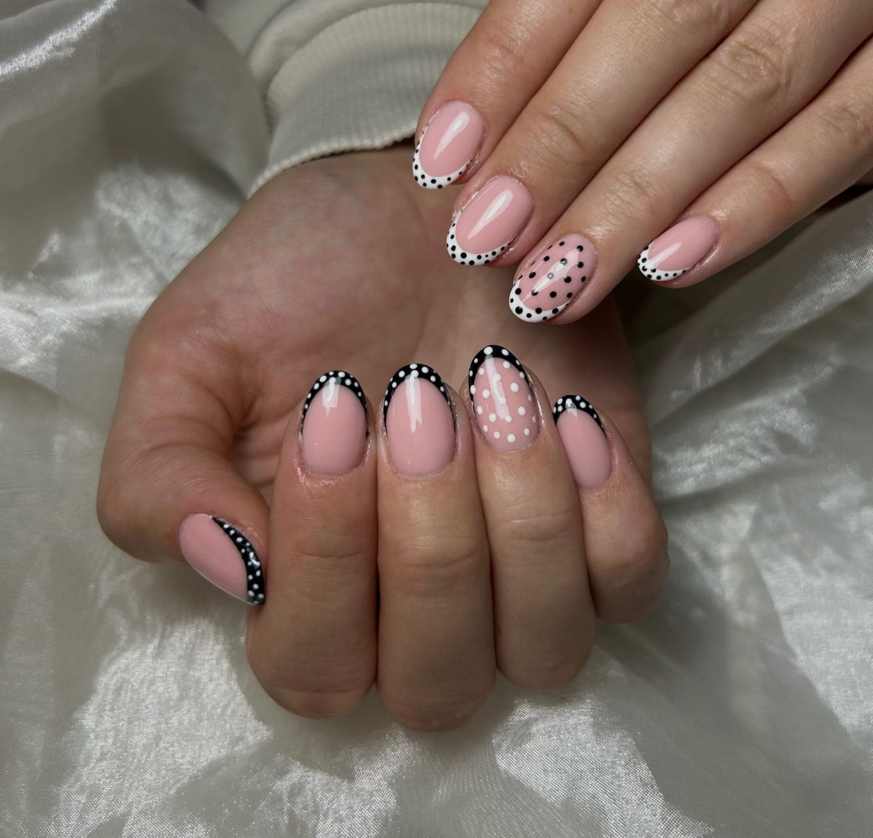 Roze nagels met een zwart-witte stippen-french en een stippenaccent — bekijk op Instagram